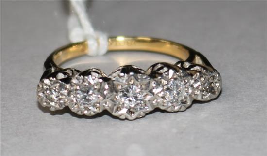 An 18ct gold, platinum and graduated five stone illusion set diamond ring, size K.